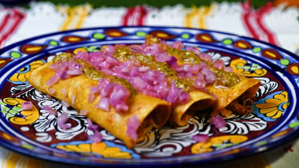 Cochinita Pibil served on a colorful plate in Mexico