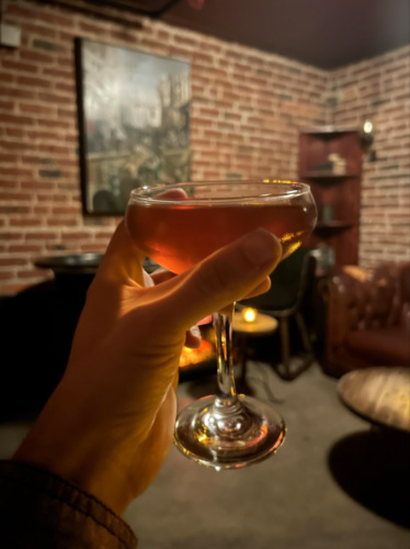 Holding a classic cocktail at Bathtub Gin & Co