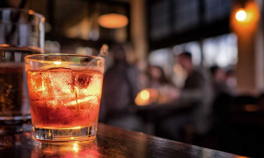 A glass of cocktail on a bar