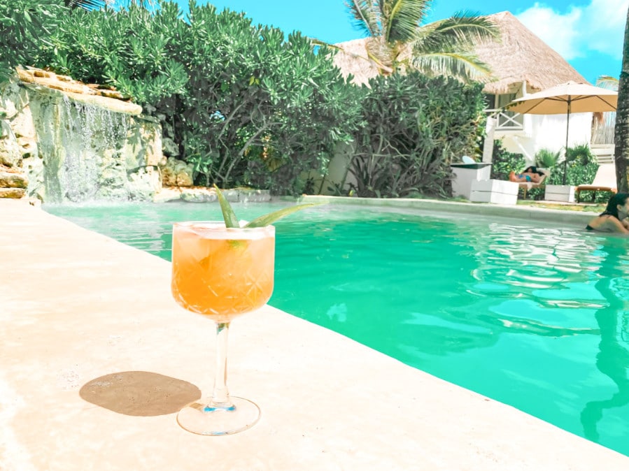 A glass of drink by the pool
