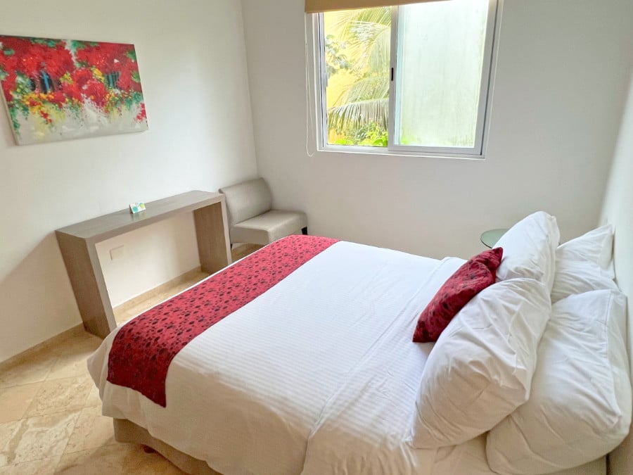 View of bed at a room in Tulum's Coco Village digital nomad apartments