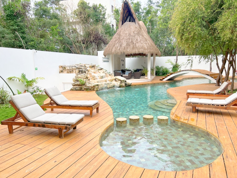 View of pool and loungers at Coco Village Tulum