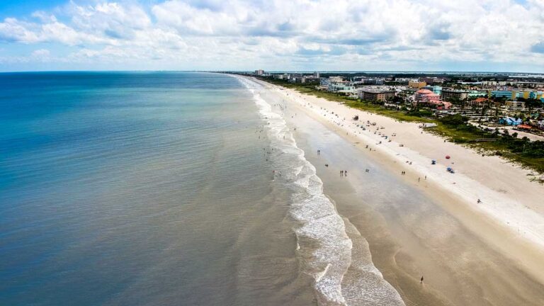 Aerial view of the white sand beach and the buildings around of Cocoa Beach
