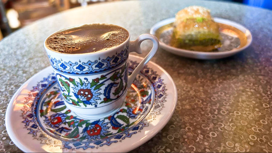 Closeup view of a cup of coffee and a plate of baklava from Ashuri Baklava Cafe