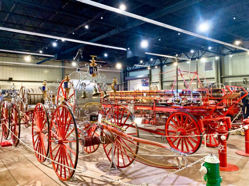 View of the hand- and horse-drawn apparatuses collection inside the Flame Fire Museum