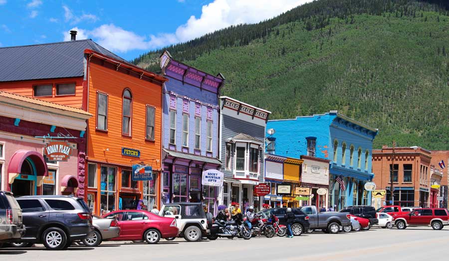 View of the colorful Greene Street with cars parked on it