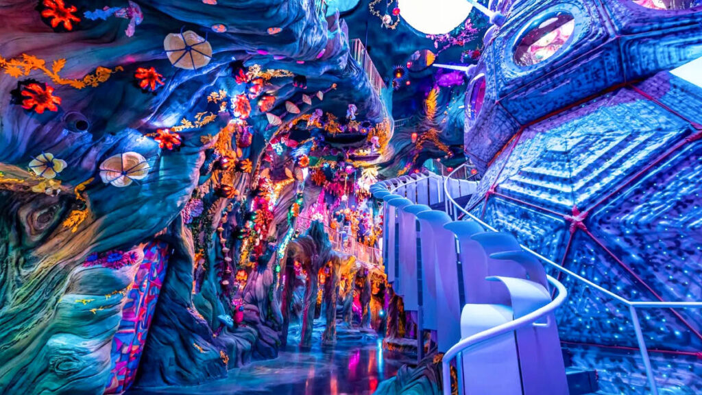 View of a staircase and the colorful interior of Meow Wolf