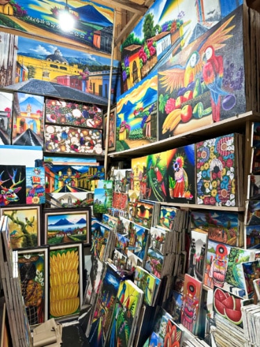 View of the vibrant and colorful paintings displayed at Mercadito
