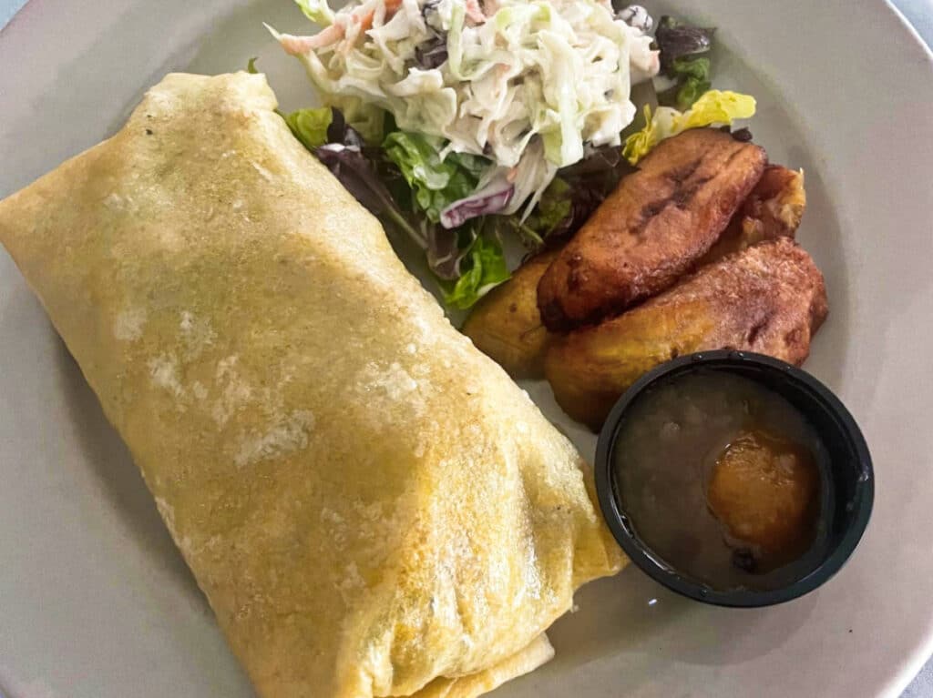 A plate of Conch roti with side dishes