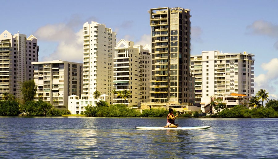 A woman paddle boarding in Condado Lagoon