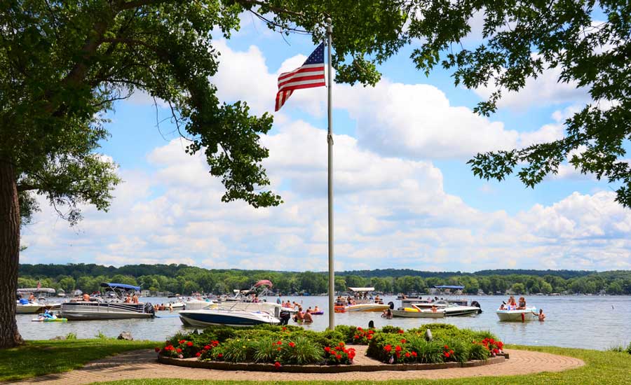 A flag of the US on a pole in Conesus Lake