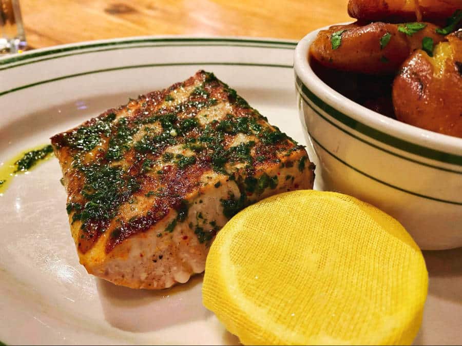 A big chunk of fish with herb oil and fingerling potatoes in Connie and Ted’s