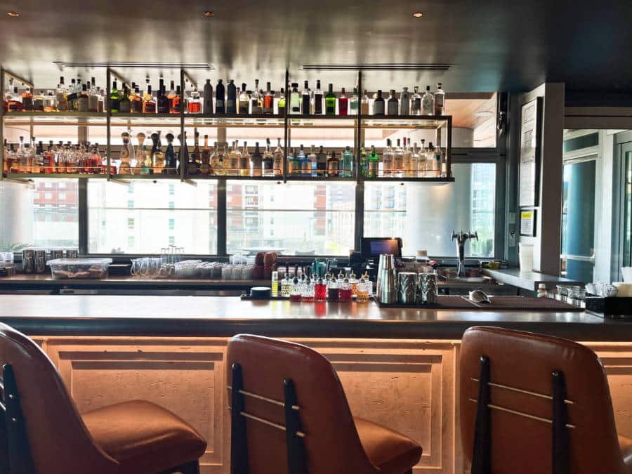 View of the displayed alcoholic drinks at the bar area in Conrad Nashville