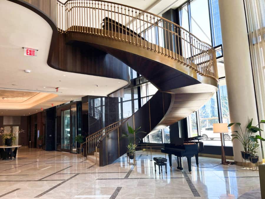 View of the grand staircase and piano at the lobby in Conrad Nashville