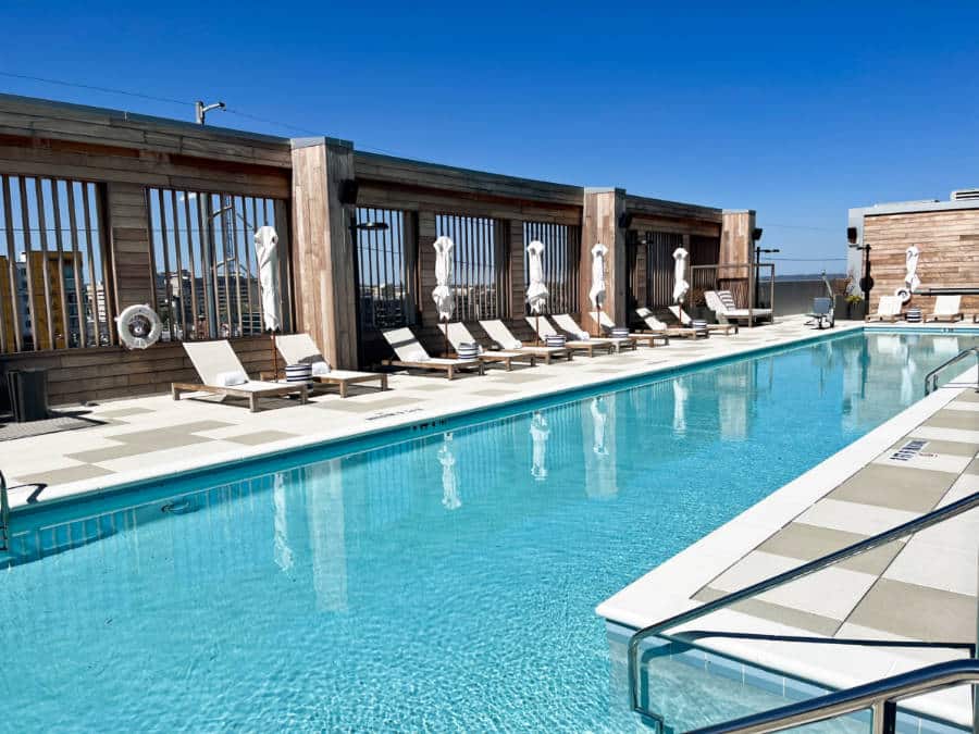 View of the lounging chairs at the pool area in Conrad Nashville
