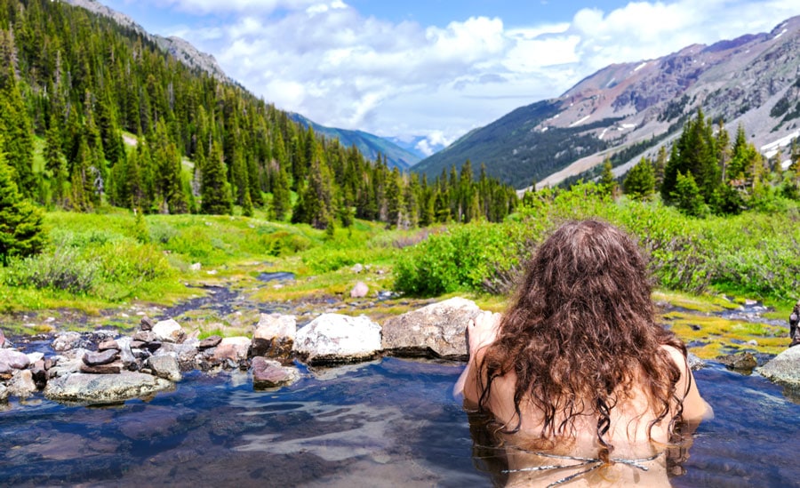 A woman admiring the scenery from Conundrum Hot Springs
