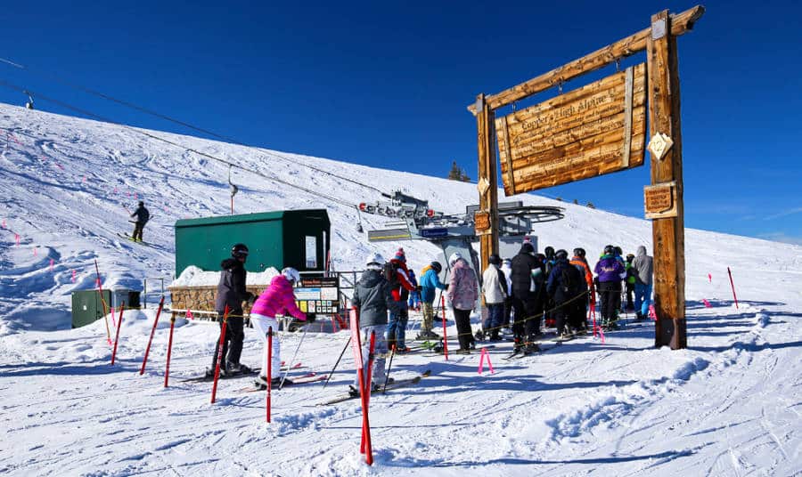 Skiers waiting in line at a ski lift in the Rocky Mountains in winter