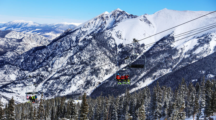 Skiers and Snowboarders riding on a ski lift in Copper Mountain