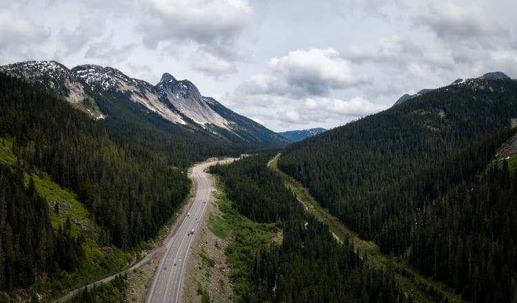 Aerial view of the scenic route passing in the valley between the mountains. Taken in Coquihalla Hwy Northeast from Hope