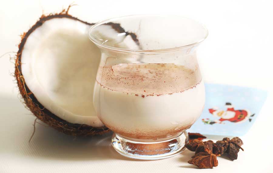 View of a coconut and coconut milk on a glass