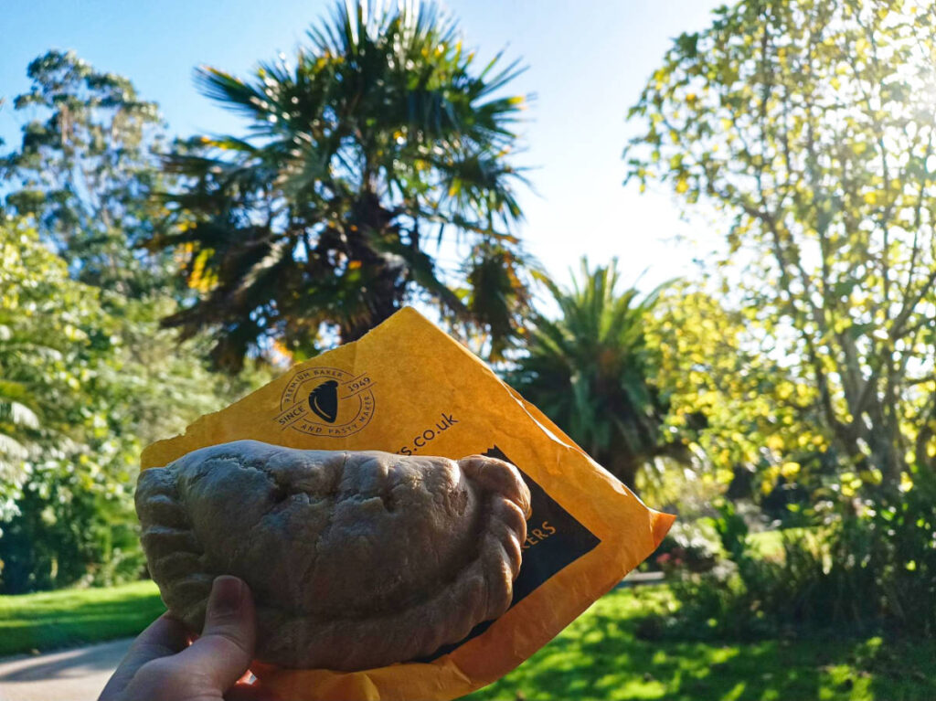 A hand holding a cornish pasty