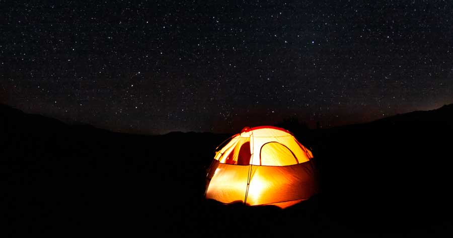Shining stars over a tent in Cosmic Campground