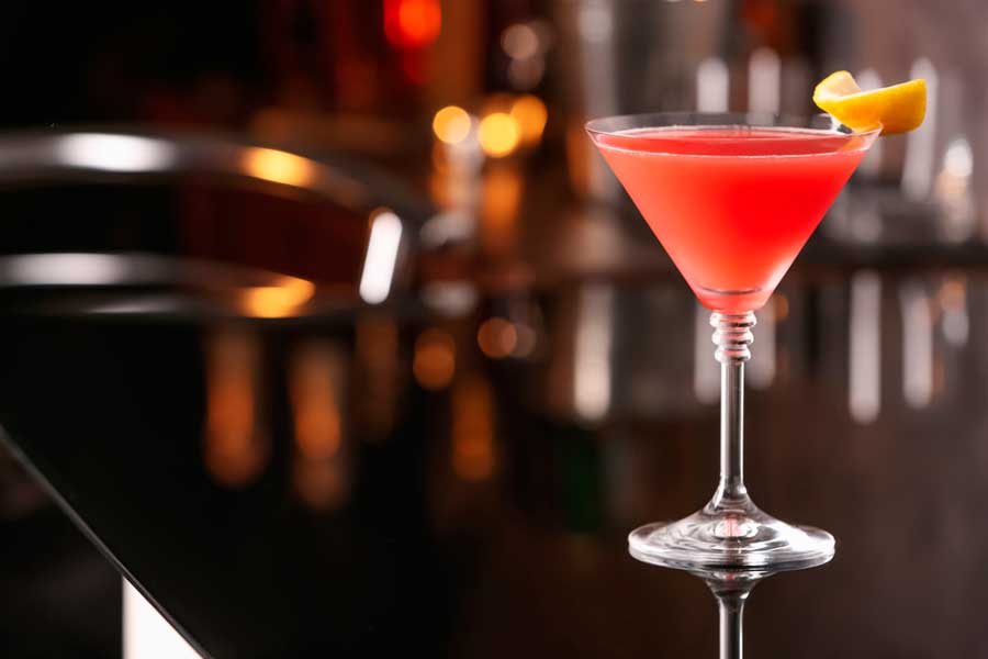 A Cosmopolitan cocktail with a lemon