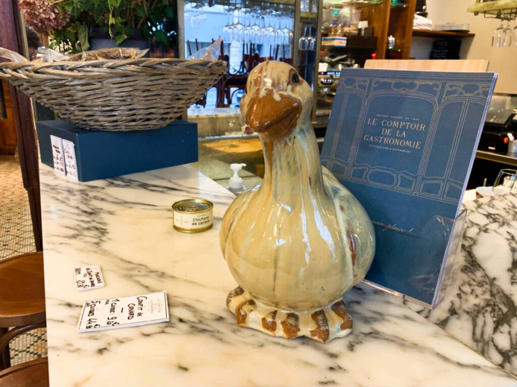 A duck figurine displayed at the counter of Le Comptoir de la Gastronomie