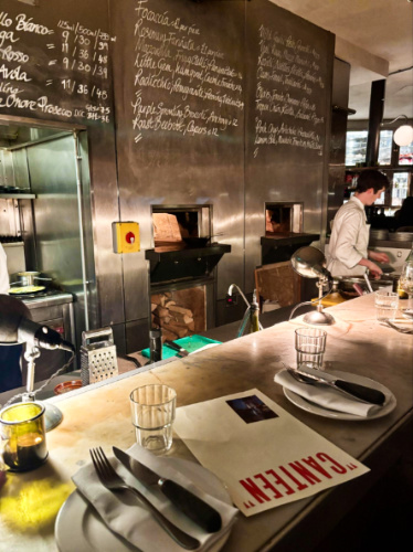 View of the chefs cooking from the counter at the Canteen