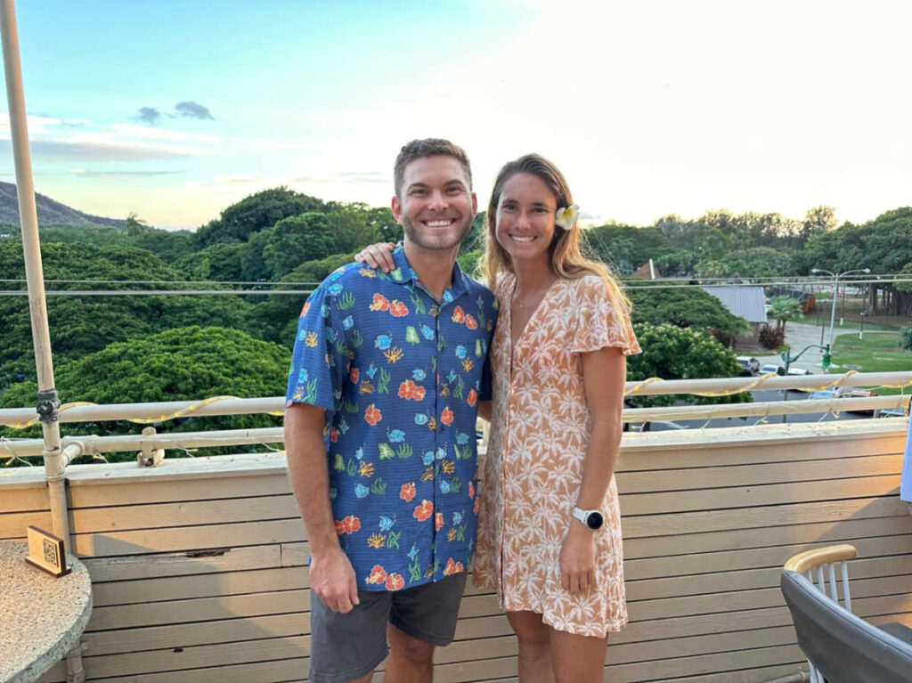 A couple smiling for a photo at The Deck in Waikiki