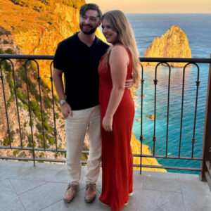 A couple enjoying the scenic overlooking view at sunset