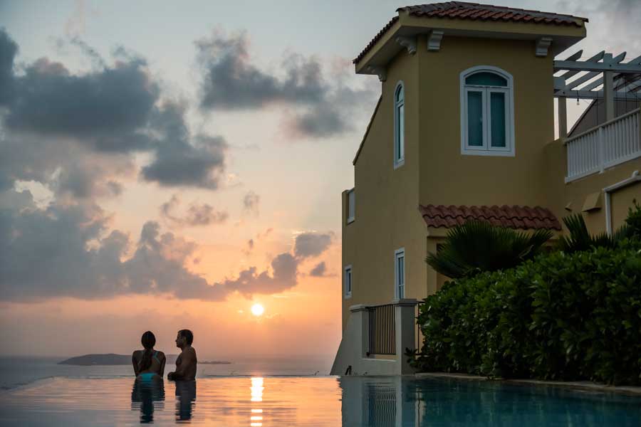 A couple enjoying their day on a pool during sunset in El Conquistador Resort