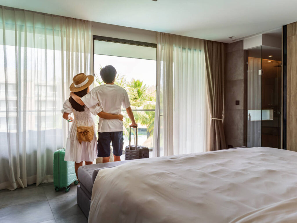 A couple checking out the view on their hotel room