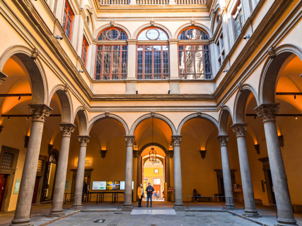 People admiring the inner courtyard at Strozzi Palace
