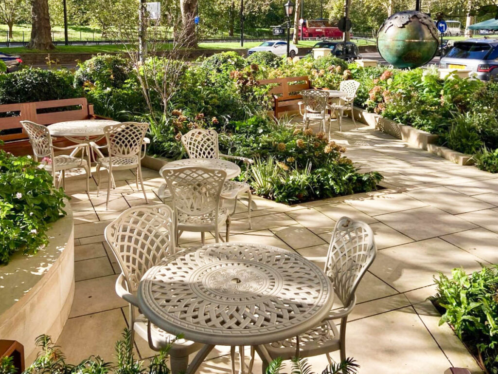 View of the outdoor tables and chairs at the courtyard of Dorchester Hotel