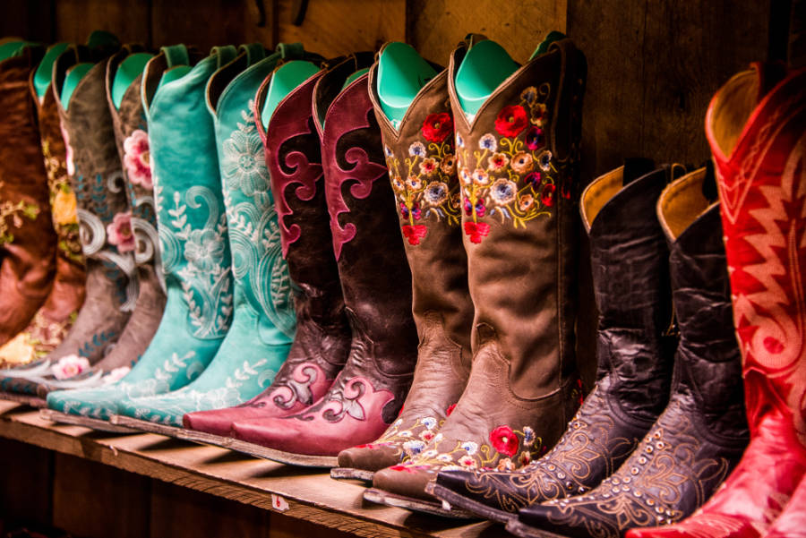 Different colors of boots displayed on a store