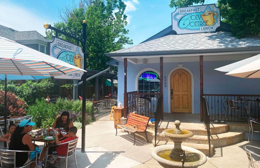 People enjoying their food at the outdoor patio of Cozy Cottage