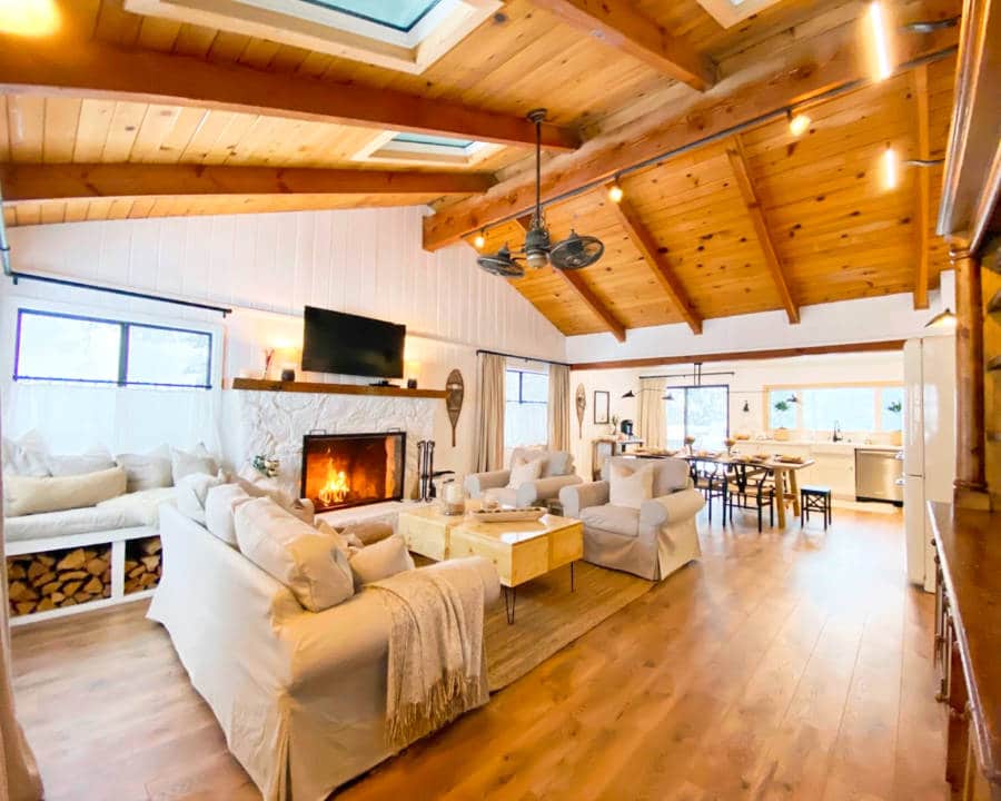 View of the cozy open living and kitchen area with a fireplace