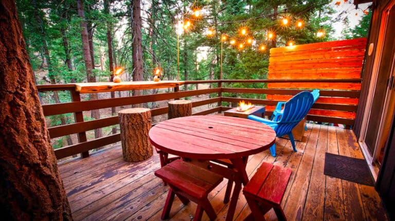 View of a balcony with cozy outdoor seating area and illuminated stringed lights