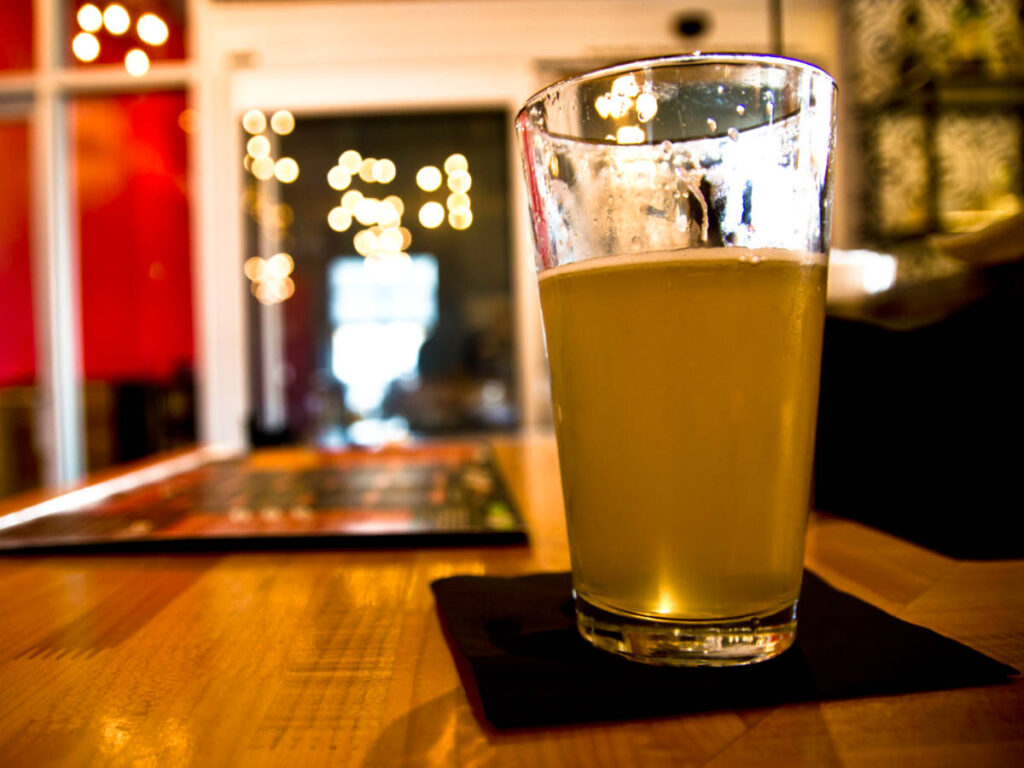 A glass of beer on the wooden table