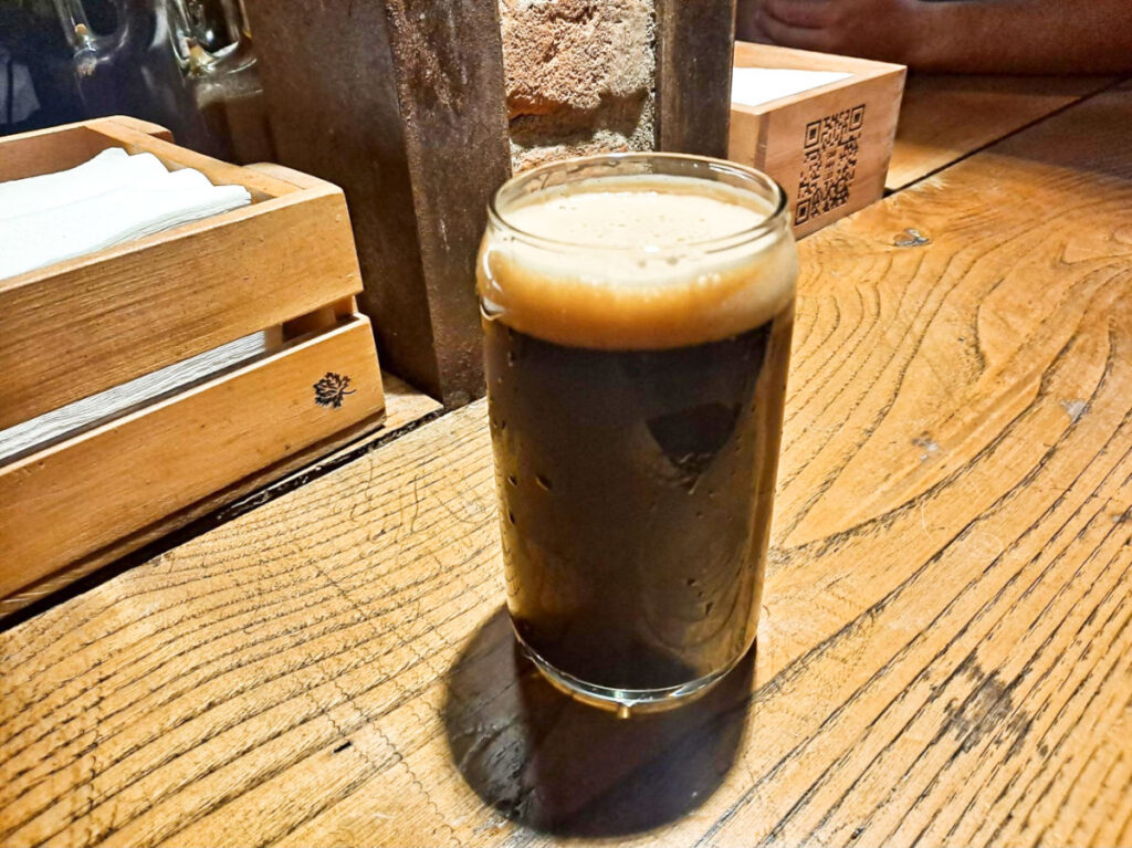 A glass of craft beer on a wooden table