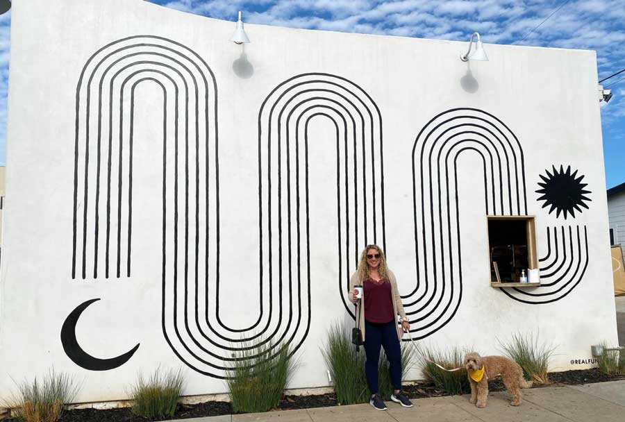 The author with her dog and the Seaborne Coffee’s mural on their background