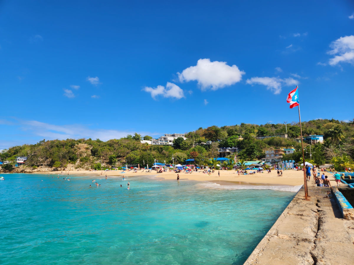 View of Crash boat Beach featuring clear waters and white sands