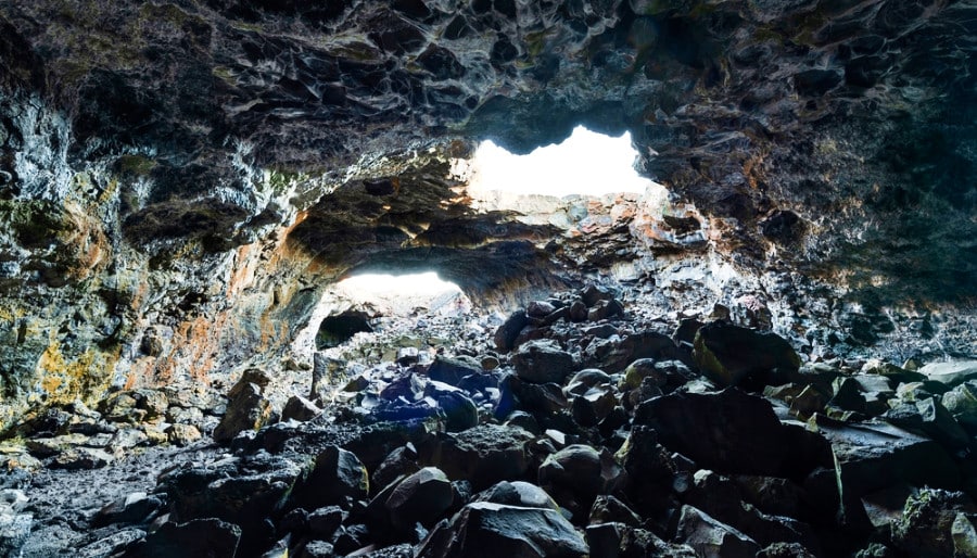 View inside the lava tubes covered with black rocks at Craters of the Moon National Monument & Preserve