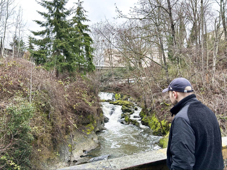 Man overlooking the river from the bridge at Maritime Heritage Park
