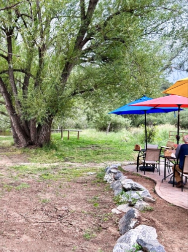 View of the colorful umbrellas on the tables at the creekside patio of Blackbird Cafe