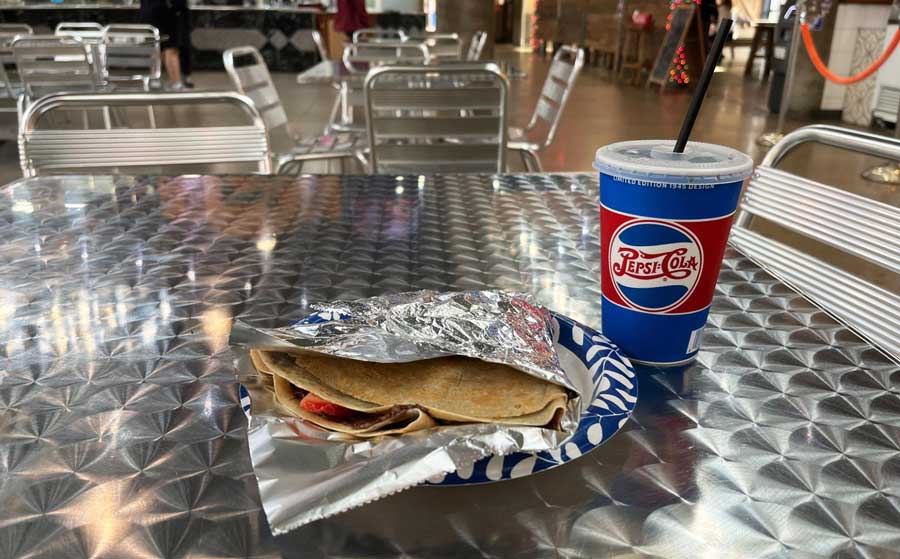 A Nutella and strawberry crepe and a pepsi cola served in Nashville Farmers' Market