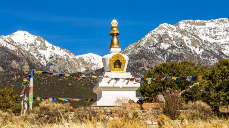 View of the Yeshe Rangsal Stupa with the snow covered mountain views in the background in Crestone, Colorado, a town featured in HBO's series Love Has Won