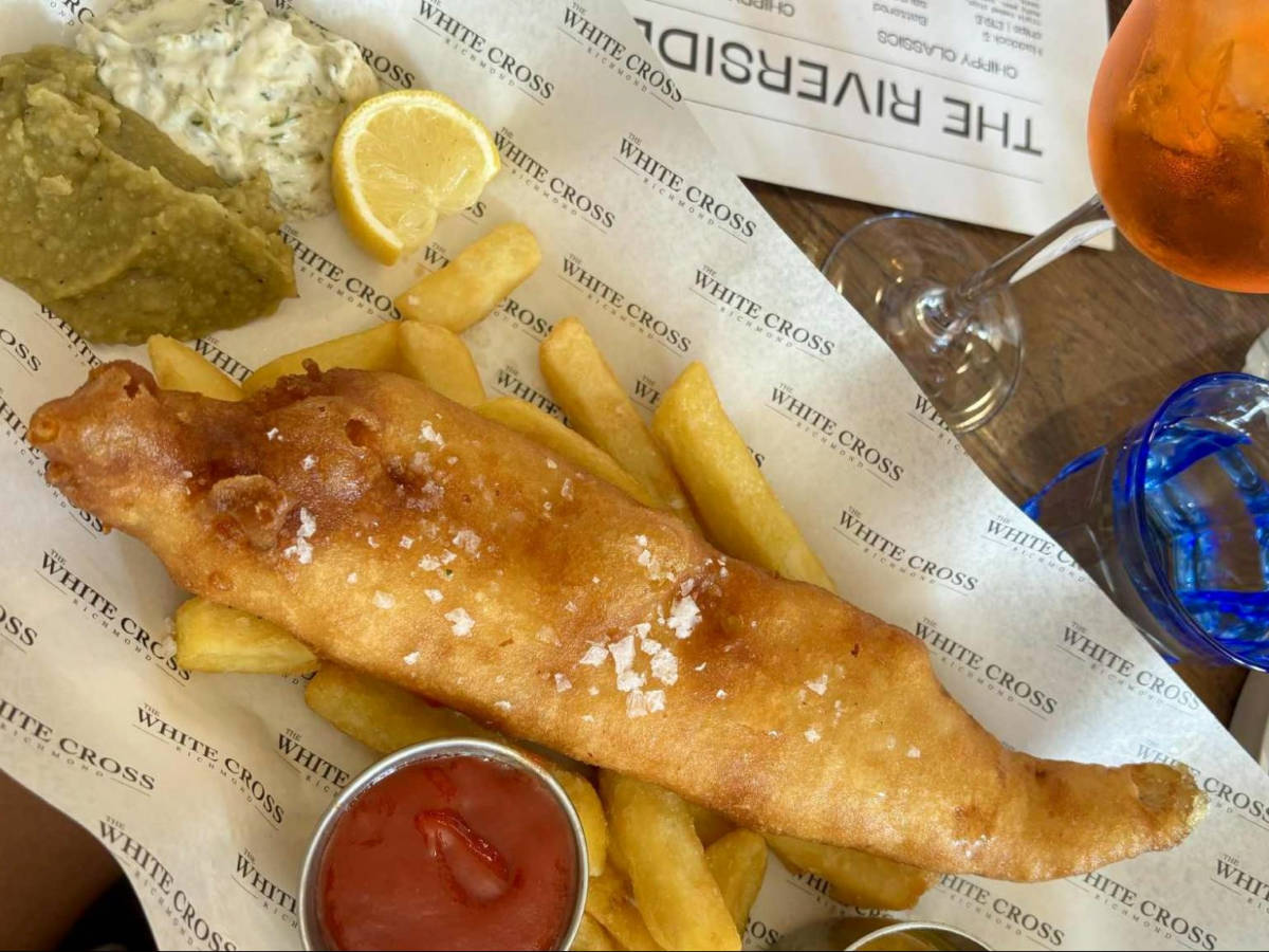 Closeup look of the crispy fish filets and chunky chips with dips on the side