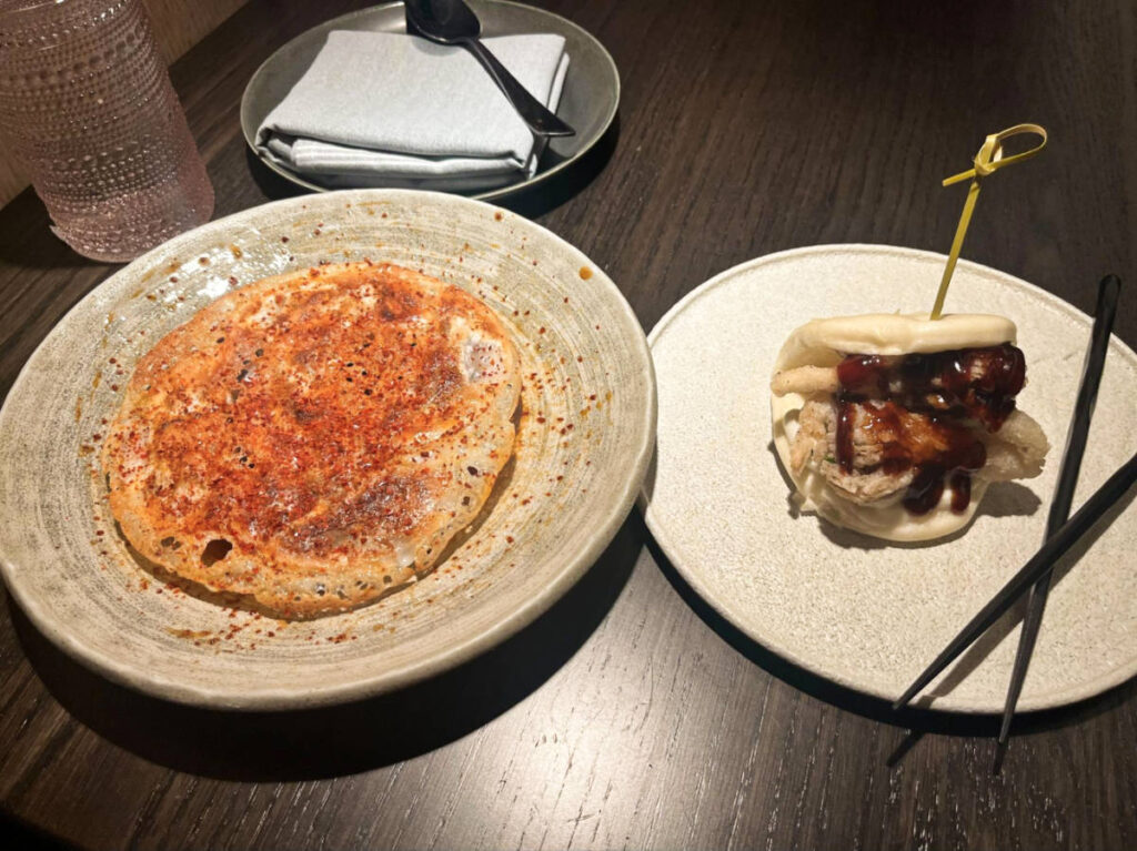 The crispy gyoza and bao slider on the plates from PLANTA Queen